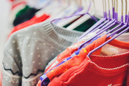 Colorful collection of womens clothes hanging on a rack.の写真素材