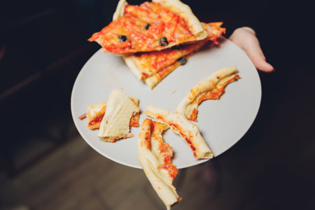 Few slices of half eaten hawaiian pizza, composition.の写真素材