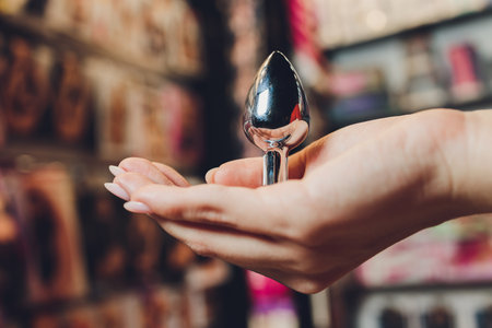 Anal plug with a fluffy tail with female hands. Toy for adult games.の写真素材