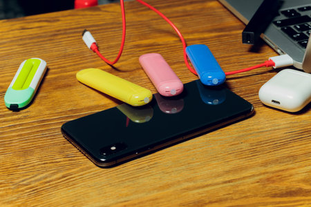 POD e-cigarette or nicotine vapor dispenser being charged in modern laptop with Pods.の写真素材