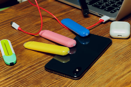POD e-cigarette or nicotine vapor dispenser being charged in modern laptop with Pods.の写真素材