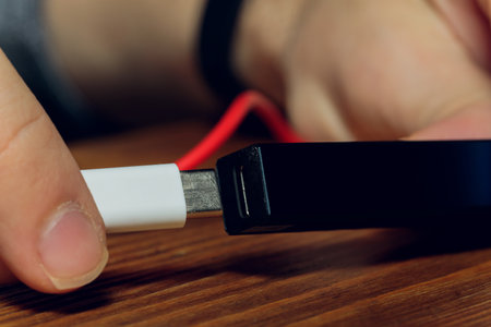 POD e-cigarette or nicotine vapor dispenser being charged in modern laptop with Pods.の写真素材