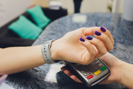Person scanning smart watch for payment close-up.の写真素材