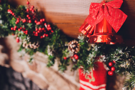Christmas stockings hanging over a fireplace with candles on the mantlepiece.の写真素材
