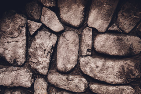 An abstract pattern created from the exterior wall of a fireplace made of rounded rocks from an old river bed.の写真素材
