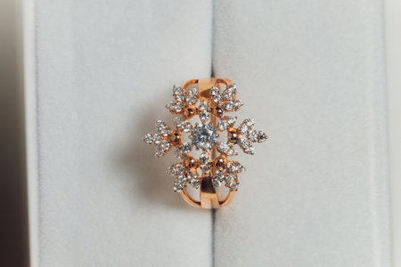 Beautiful new pair of elegant white gold wedding rings and white gold engagement ring, white square ring box.の写真素材