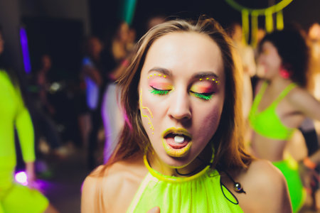 beautiful girl with lsd on tongue in nightclub with pink smoke.の写真素材