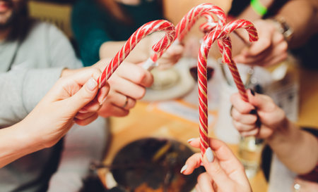 Christmas candy canes in the hands of a child. Selective focus. Holiday.の写真素材
