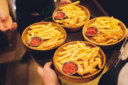 tray of fries and sauce on four plates  close-up.