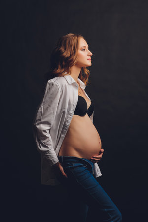 Young beautiful stylish pregnant woman posing in black underwear.の写真素材