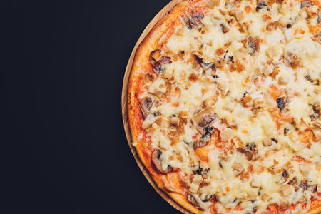 Slices of pizza on rustic wooden tray and dark background.の写真素材