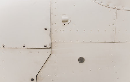 Aluminum surface of the aircraft fuselage. Smooth rows of rivets, there are scratches, dirt.の写真素材
