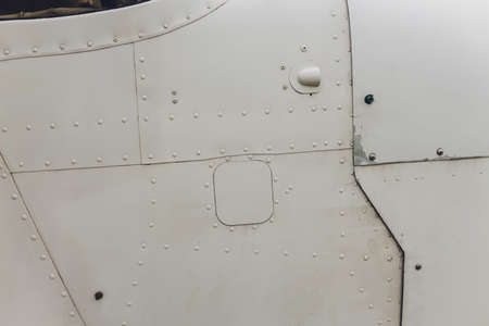 Aluminum surface of the aircraft fuselage. Smooth rows of rivets, there are scratches, dirt.の写真素材