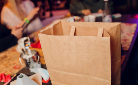 dessert paper bag waiting for customer on counter in modern cafe coffee shop, food delivery, cafe restaurant, takeaway food.の写真素材