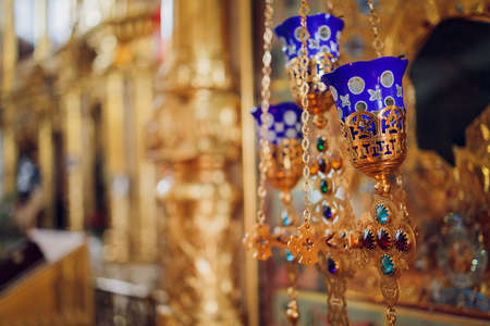 Lighting candles in a catholic temple . Candles are lit near the altar in a Catholic temple.の写真素材