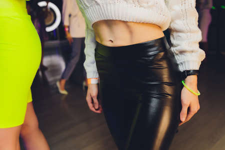 Close up of pretty woman pinching skin of her hip.の写真素材