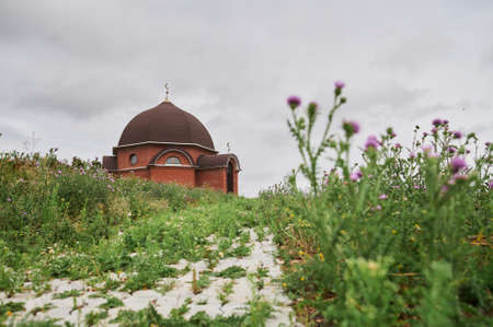 Mosque under construction against the blue sky, finishing work of minarets.の写真素材
