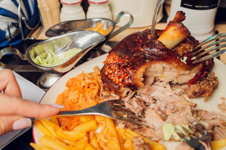 Roast pork knuckle on a wooden board. Selective focus.の写真素材
