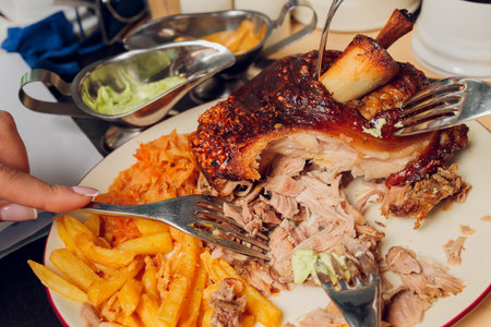 Roast pork knuckle on a wooden board. Selective focus.の写真素材