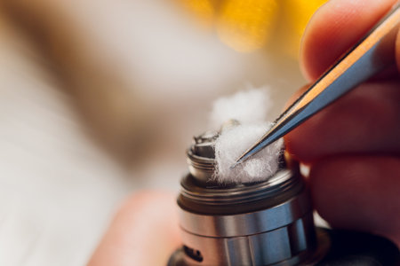 Specialist replaces spring for smoking vape.Professional maintaining electronic cigarette in...