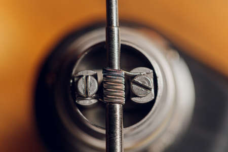 Specialist replaces spring for smoking vape.Professional maintaining electronic cigarette in...