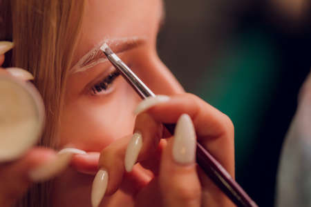 Eyebrows tinting treatment with natural henna dye.