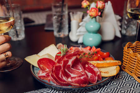 Breakfast plate with traditional spanish food, jamon, fried egg, potato tortilla and salami chorizo high angle view.の写真素材