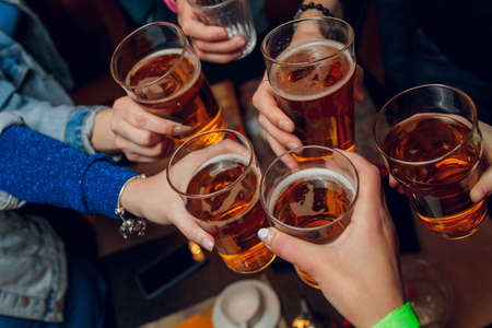 Clinking glasses with alcohol and toasting, party.の写真素材