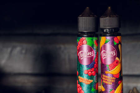 Ufa, Russia, 5 July, 2020: E-liquid e-juice High vape for electronic cigarette vaping device , on counter in smoke vapor in vape bar in bottles. brandのeditorial素材