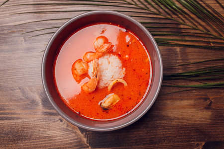 Tom Yum Goong Spicy Sour Soup on Marble table top view, Thai local food.