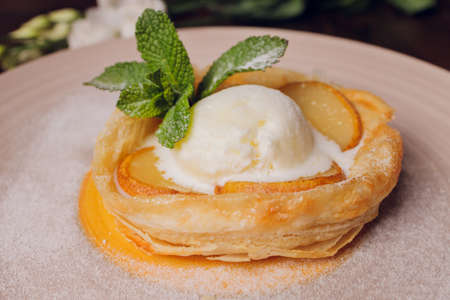 Apple Strudel with Ice Cream. On a wooden background. Top view. Free space for text.