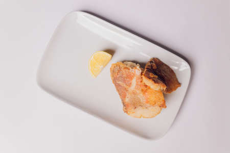 Battered fish fillet isolated over white background.の写真素材