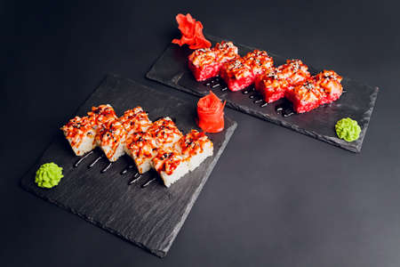 Traditional japanese food, Mix colorful sushiSet of different kinds of sushi rolls with salmon, shrimp and vegetables. On black rustic background. Top view.の写真素材