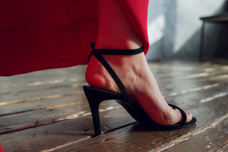 a womans foot in a shoe got stuck in the wood floor. hole.