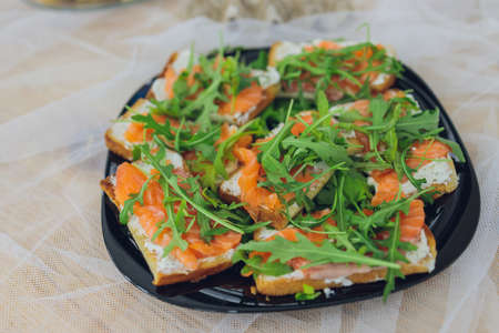 Beautifully decorated catering banquet table with different food snacks and appetizers with...