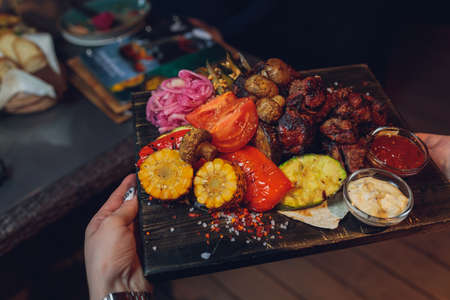 Beef steak with grilled vegetables and seasoning on serving board block.の写真素材