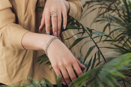 Womans hands with perfect manicure with silver bracelet.の写真素材