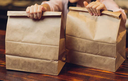dessert paper bag waiting for customer on counter in modern cafe coffee shop, food delivery, cafe restaurant, takeaway food.の写真素材