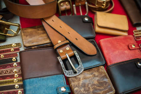 Different hand made leather man accessories on wooden background.の写真素材