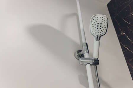 Water flowing in a old metal shower - swallow DOF.focus on top.some water drops are blurry due to water speed.の写真素材