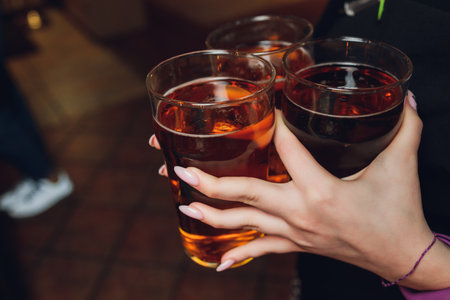 Woman holding three glasses of beer bartender.