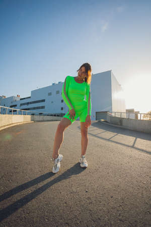 Running in city park. Woman runner outside jogging at morning with urban scene.の写真素材