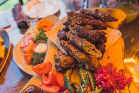 traditional Georgian lula kebab with three types sauce - ketchup, green tkemali, mayonnaise. Selective focused.の写真素材