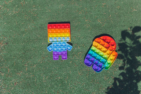 Anonymous child hold in his hands sensory toy  and shows it in front of himself.Rainbow color.Antistress toy for children and adult.の写真素材