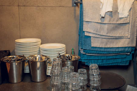 Restaurant waiter serves a table, close-up. The waiter serves empty tableware, table setting. The waitress puts the fork, sets the tableの写真素材