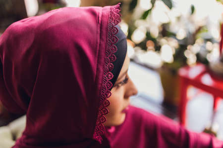 Arabian young muslim woman sitting in a cafe.の写真素材