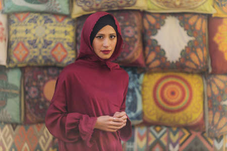 Arabian young muslim woman sitting in a cafe.