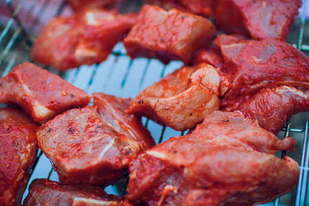 Close-up Of BBQ Roast and Smoked Pork Baby Back Spareribs On The Hot Charcoal Grill With Flames Isolated On Black Background.の写真素材