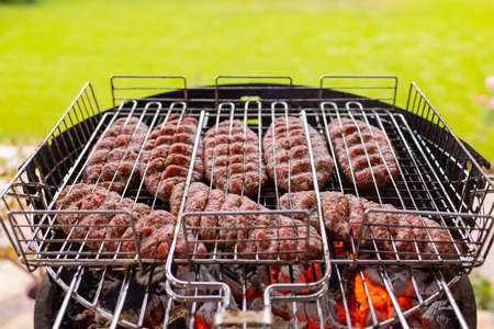 Hamburgers cooking on the grill, copy space.