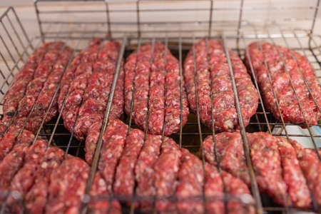 Hamburgers cooking on the grill, copy space.の写真素材